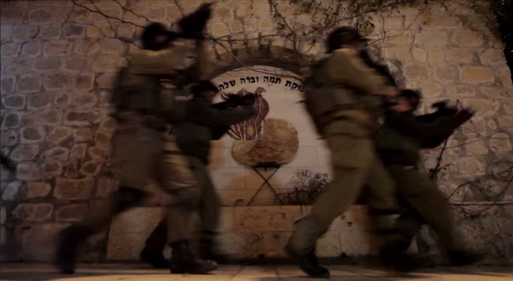 Mendy Pellin shoots a scene for a music video in front of a memorial in Chevron (Hebron) for a baby (Shalhevet Pass) that was shot playing in her front yard.